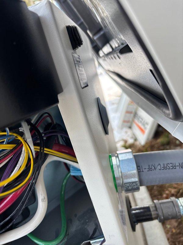 Successfully completed installation of 22kW Guardian generator with 90' of electrical line and 30' of gas line. Interior wiring connections were properly installed with color-coded harnesses secured within the housing enclosure. Electrical integration was completed at the main breaker panel with appropriate circuit connections and conduit installation.