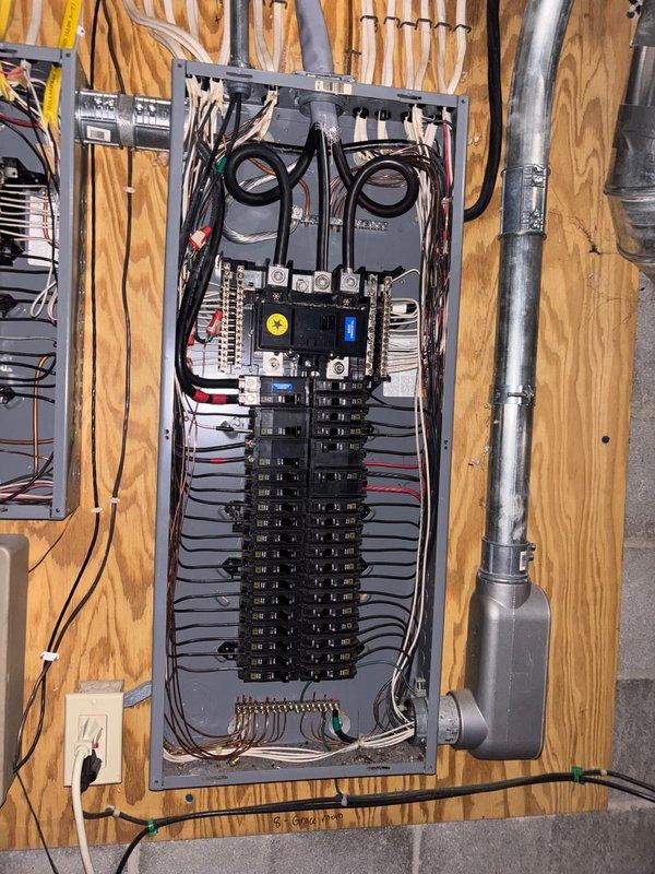 Successfully completed installation of 22kW Guardian generator with 90' of electrical line and 30' of gas line. Interior wiring connections were properly installed with color-coded harnesses secured within the housing enclosure. Electrical integration was completed at the main breaker panel with appropriate circuit connections and conduit installation.