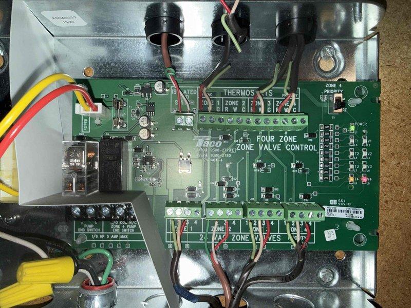 Diagnosed and repaired 3-year-old heating system with zone control valve issue. Inspection of the Four Zone Valve Control board revealed non-functioning indicator light for affected zone. Replaced faulty zone control module and verified proper operation of all zones with successful system testing.