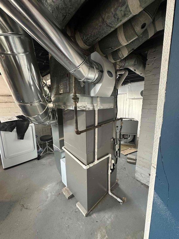 Completed installation of a 90% efficiency furnace with comprehensive ductwork modifications and humidifier system. Installed new galvanized sheet metal ductwork with proper connections to existing distribution system. Mounted Kidde carbon monoxide detector as part of safety compliance measures.