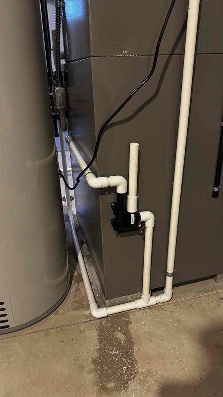 Replaced damaged PVC condensate drain trap that was causing water leakage. Installed new 3/4" PVC piping with proper configuration and fittings to ensure proper drainage from the system. Verified operation with no leaks after installation.