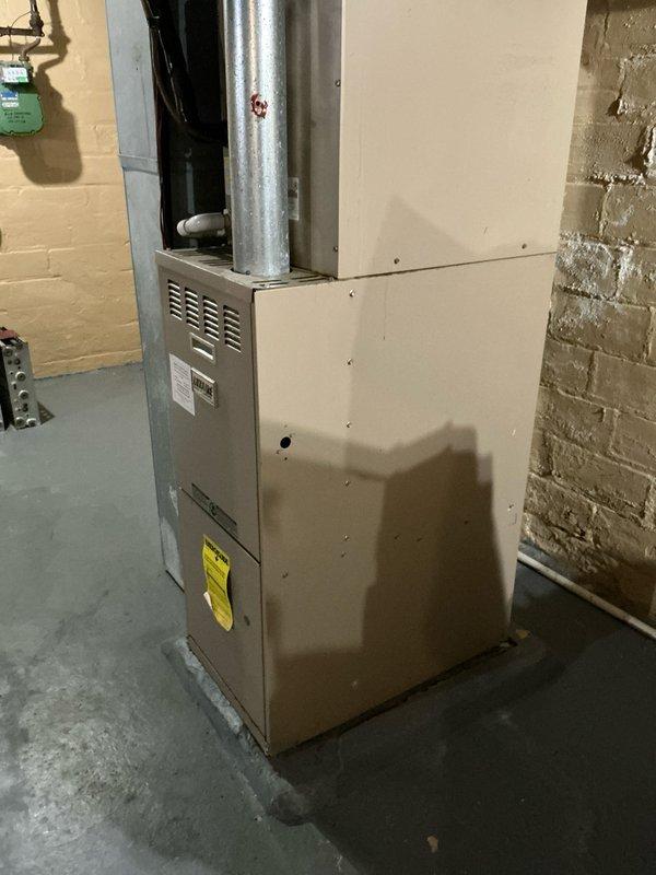 Responded to service call for no heat in aging HVAC system. Inspection revealed 20+ year old furnace with deteriorating components and compromised ductwork. Recommended complete system replacement based on unit age, visible wear on cabinet housing, and inefficient ducting configuration observed in the mechanical area.