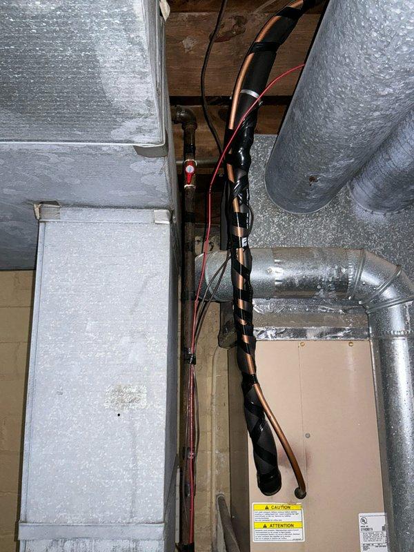 Responded to service call for no heat in aging HVAC system. Inspection revealed 20+ year old furnace with deteriorating components and compromised ductwork. Recommended complete system replacement based on unit age, visible wear on cabinet housing, and inefficient ducting configuration observed in the mechanical area.