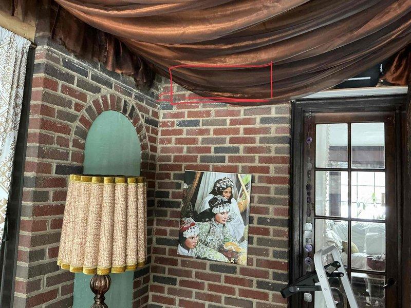 Conducted site evaluation for mini split installation in sunroom with brick construction. Assessed both interior and exterior mounting options, noting the exposed brick walls inside and exterior access points. Evaluated electrical requirements and potential line set routing for optimal system placement.