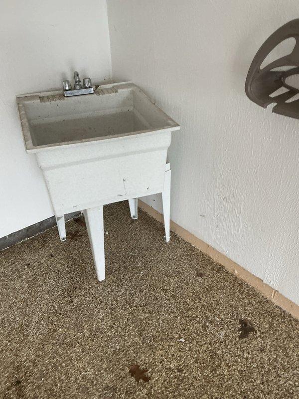 Located and repaired a burst pipe in garage wall that was leaking water near utility sink and through an electrical outlet. Shut off water supply, removed damaged section of wall to access the compromised copper pipe, replaced the affected pipe segment, and verified proper water flow with no leaks after repair.