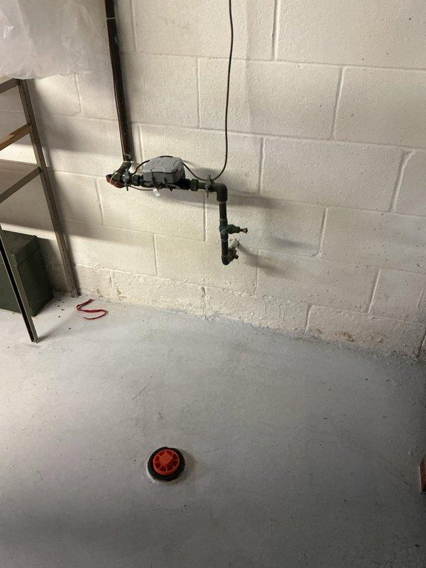 Conducted free assessment of existing Richmond tanked water heater for potential replacement. Examined current installation including supply/return lines, ventilation ducting, and valve connections. Inspected floor drain and wall-mounted plumbing configuration to evaluate replacement options and requirements.