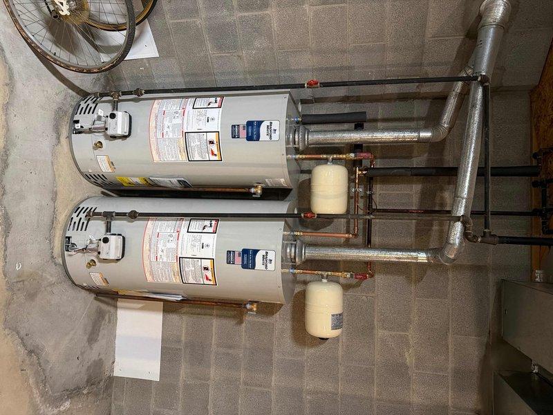 Successfully replaced two 2014 40-gallon short water heaters with new Bradford White units featuring 6-year manufacturer warranties. Work included replacing ball valves, rebuilding water lines to accommodate the new tanks, and installing thermal expansion tanks for each unit. Customer received a one-year maintenance value plan with all associated benefits and discounts.