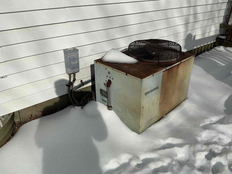 Completed removal of existing 80% efficiency lowboy furnace and air conditioning unit. Installed new mint green furnace with proper ductwork connections in basement utility area. All old equipment was hauled away from the property. System installation verified complete with proper connections to existing ductwork.