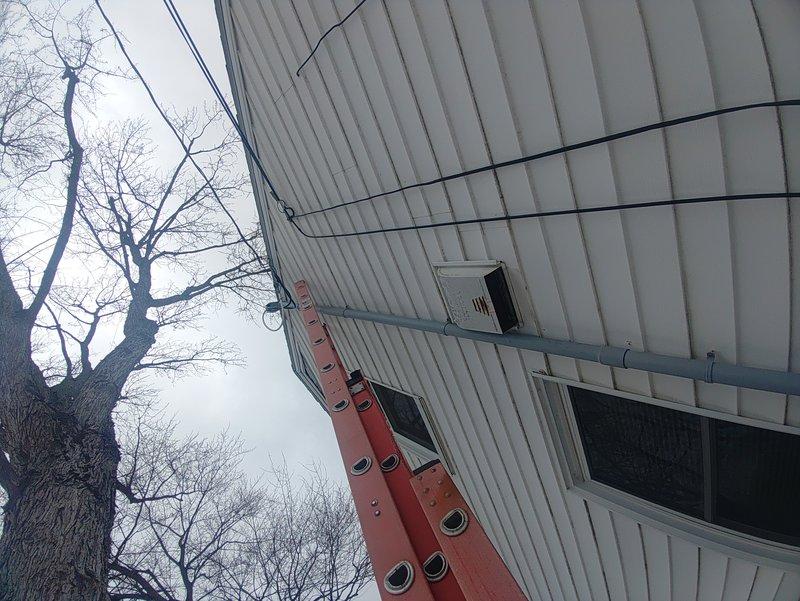 Completed 200 amp service installation with parallel weatherhead installation. Mounted new meter box on exterior wall and installed circuit breaker assembly with proper connections. Work was performed by single technician over 8-hour period with confirmed right height placement. No disconnect required as per specifications.