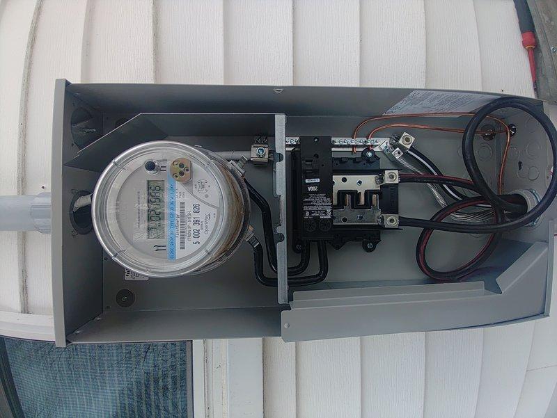 Completed 200 amp service installation with parallel weatherhead installation. Mounted new meter box on exterior wall and installed circuit breaker assembly with proper connections. Work was performed by single technician over 8-hour period with confirmed right height placement. No disconnect required as per specifications.