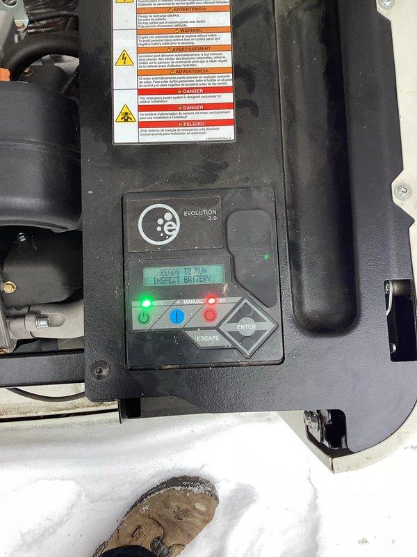 Responded to service call for generator with yellow and green flashing lights. Upon inspection of the Generac Evolution unit, the control panel displayed "PRESS TO RUN INSPECT BATTERY" warning message. Diagnosed battery issue as indicated by control panel diagnostics and replaced battery to restore proper generator functionality.