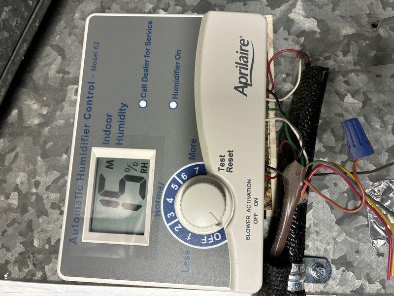 Performed routine MVP furnace maintenance service on Lennox heating system. Inspected Aprilaire Model #60 humidifier control, noting 0% humidity reading on digital display. Examined furnace connections including copper and PVC piping, ductwork, and associated plumbing components. Documented system condition with photos for service record.