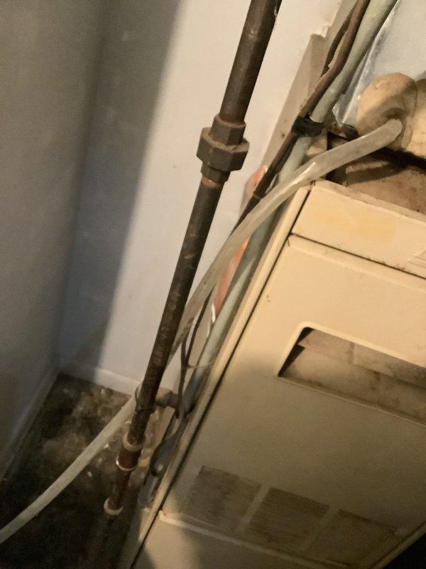 Conducted assessment of 44-year-old heating system requiring replacement. Inspected aging Lennox furnace with deteriorating copper lines, visible corrosion on pipe unions, and compromised ductwork connections. Photographed existing system configuration to develop appropriate replacement solution.