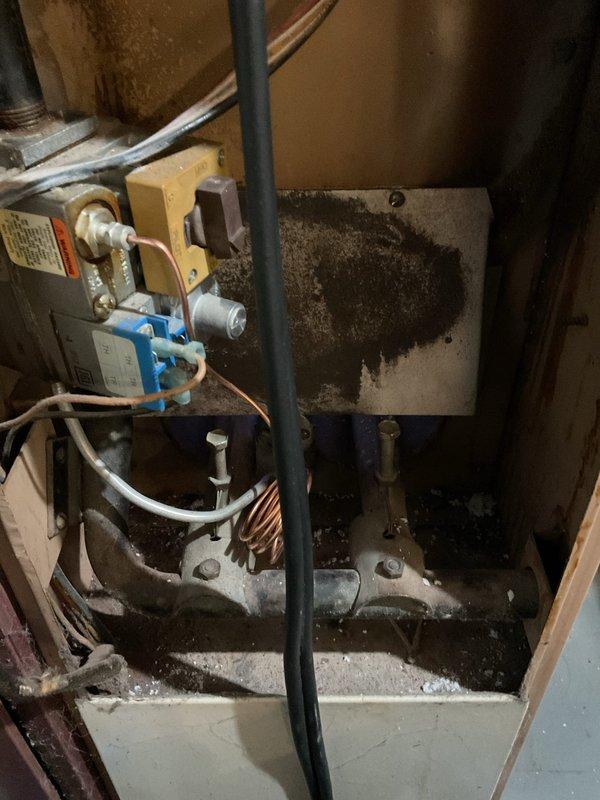 Diagnosed non-functioning heating system with significant corrosion and rust on heat exchanger. Inspection revealed deterioration of metal components and potential safety hazards. Recommended system replacement due to age-related wear and compromised operational integrity.