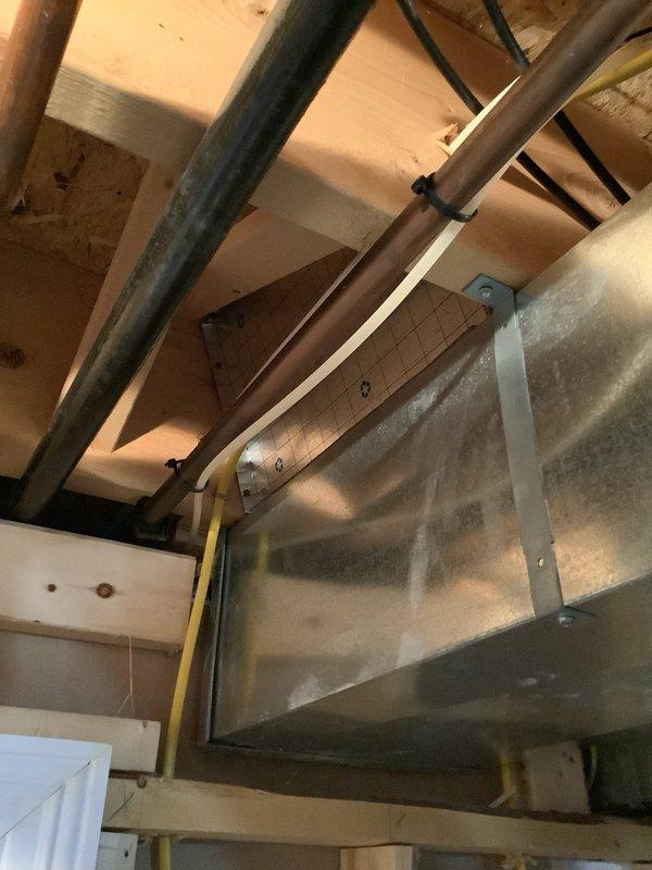 Responded to customer report of water leak in refrigerator area affecting basement. Diagnostic inspection revealed issue with copper water supply line connection to refrigerator. Located and repaired faulty pressure regulator valve in supply line system as evidenced by gauge readings. Checked surrounding ductwork and adjacent plumbing for collateral damage; confirmed repair resolved the leak source.