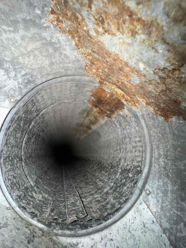 Completed comprehensive duct cleaning service on a 14-vent HVAC system, addressing significant corrosion and deterioration identified within the ductwork. Documented pre-service conditions showing extensive oxidation in metal components and structural damage to vent cavities, which were thoroughly cleaned and sanitized to improve system efficiency and indoor air quality.