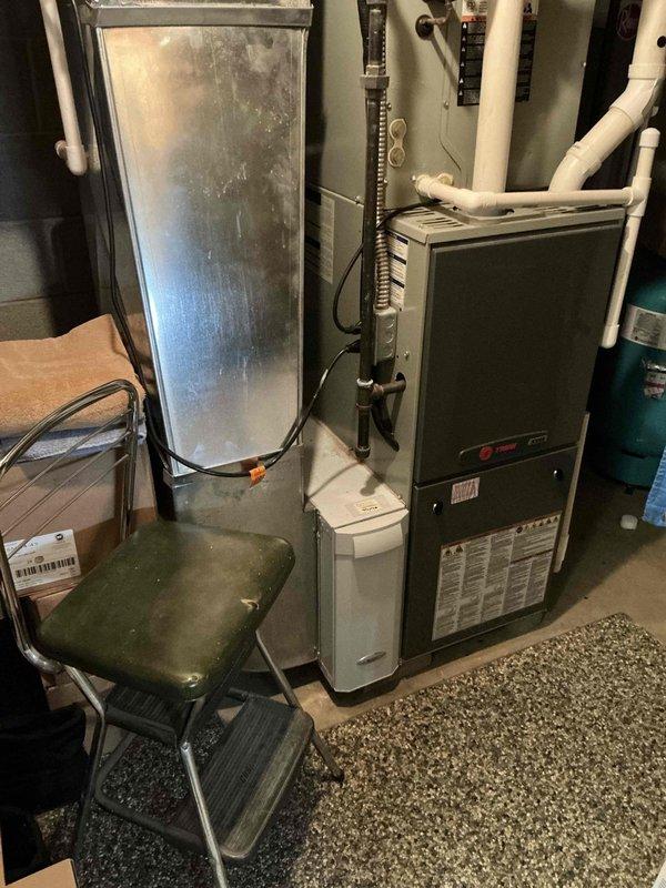 Completed inspection of 13-year-old heating system with confirmed cracked heat exchanger. Documented existing equipment including furnace and outdoor AC unit requiring replacement. Provided estimate for complete system replacement with new furnace and positive air conditioning system.