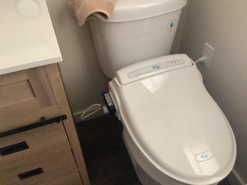 Completed toilet replacement in first floor bathroom, retaining customer's existing bidet seat and successfully transferring it to the new customer-supplied fixture. Also performed snaking of 3" horizontal drain from basement cleanout in high rough sewer system connected to septic, which required drilling access through cleanout cap to drain down system before servicing.