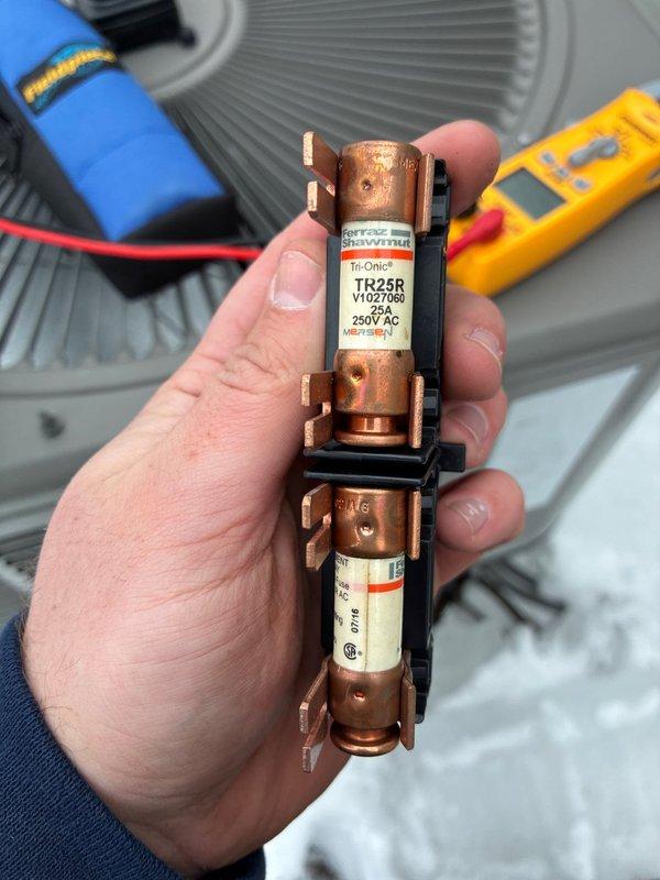 Performed maintenance on 9-year-old heat pump system for MVP customer. Inspected heat exchanger coils which showed normal condition with proper fin spacing. Removed and examined fuse assembly (TR25R 250V AC), tested electrical components with multimeter, and verified proper operation.