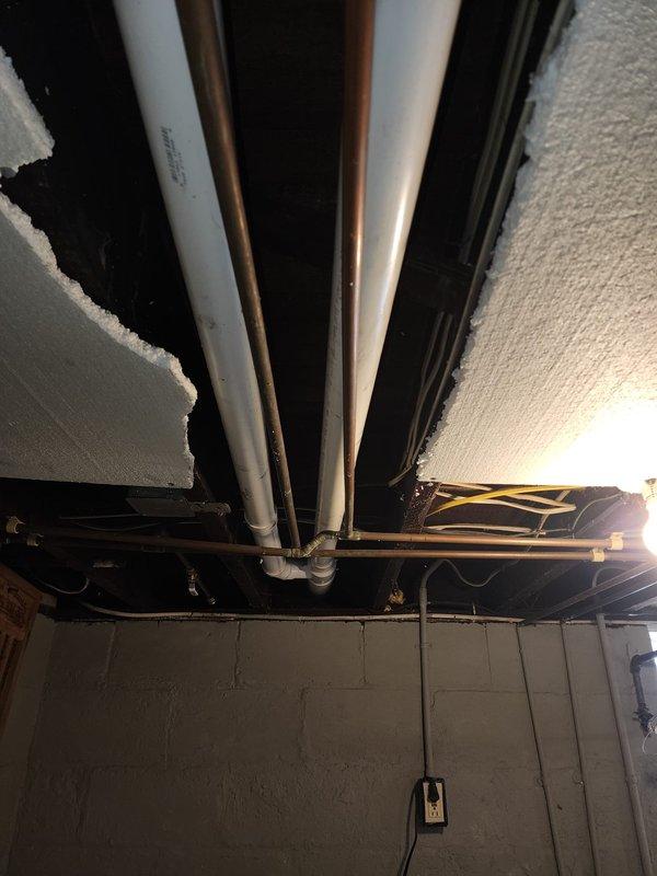 Successfully installed a new 93% efficient furnace in the basement utility room. The installation included proper connection of white PVC venting pipes and copper lines, with all components securely mounted against the concrete block wall. Visual inspection confirms clean installation with appropriate clearances and proper integration with existing mechanical systems.