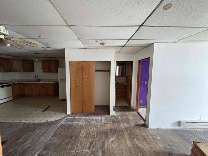 Conducted site assessment for mini-split installation in a residence undergoing renovation. Evaluated electrical capacity in utility room with existing panels to determine appropriate power requirements. Noted significant ceiling water damage and worn flooring in main living area that may impact indoor unit placement options. Further consultation needed to finalize system specifications and optimal mounting locations.