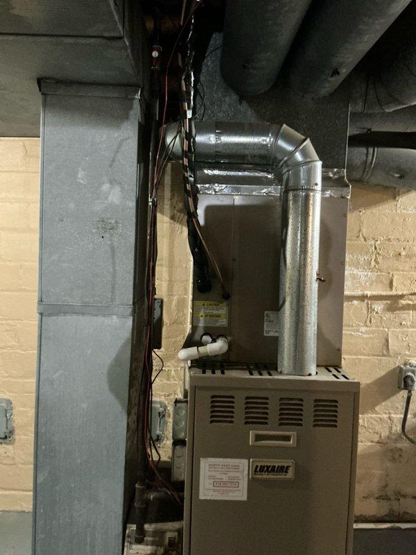 Installed new 80% efficient Luxaire furnace with complete ductwork system in basement. Installed copper refrigerant lines with proper insulation and electrical connections for the AC unit. All connections were properly sealed with metal tape at joints, and system was tested for proper operation.