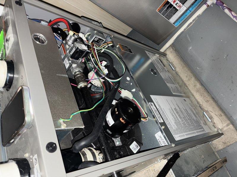 Responded to customer complaint of loud, potentially dangerous noise from furnace blower that began after recent hot water tank installation. Upon inspection of the 7-10 year old unit, removed access panels to examine blower assembly and internal components. Discovered foreign debris interfering with blower wheel operation, removed obstruction, and verified normal operation. System now functioning properly with no unusual noise.