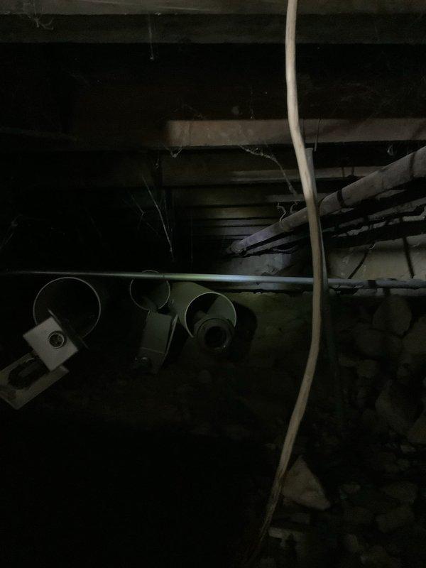 Responded to service call for 8-year-old boiler system with significant corrosion issues. Upon inspection, found severe deterioration on cast iron radiator including a penetration hole with substantial rust damage. Basement inspection revealed poor maintenance conditions with multiple pipe systems requiring attention.
