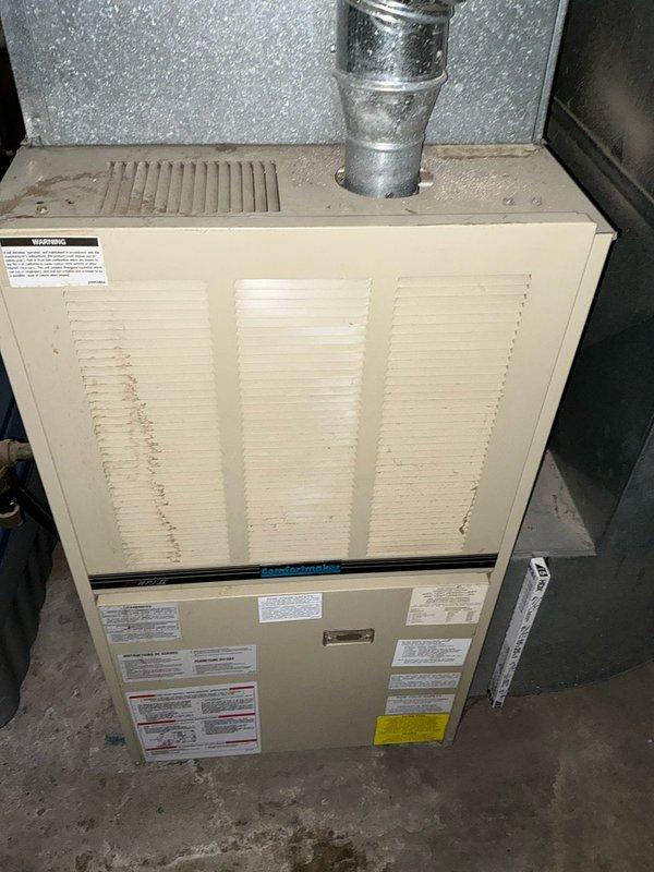 Performed inspection of 33-year-old heating system, documenting existing basement installation with significant age-related wear. Provided replacement estimate for new furnace system, including upgraded sheet metal ductwork, proper condensate drainage, and all necessary ventilation components.
