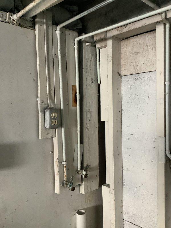 Conducted assessment of reported burst pipe in basement utility area. Inspected exposed plumbing system including PVC drainage pipes and supply lines. Documented condition with photographs of main utility area and under-sink P-trap assembly. Found no active leaks or damage requiring immediate repair.