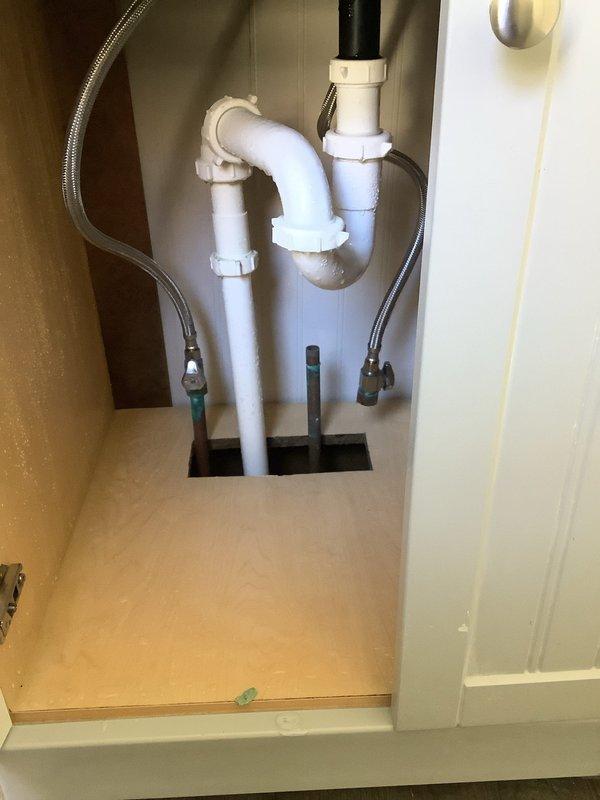 Conducted assessment of reported burst pipe in basement utility area. Inspected exposed plumbing system including PVC drainage pipes and supply lines. Documented condition with photographs of main utility area and under-sink P-trap assembly. Found no active leaks or damage requiring immediate repair.
