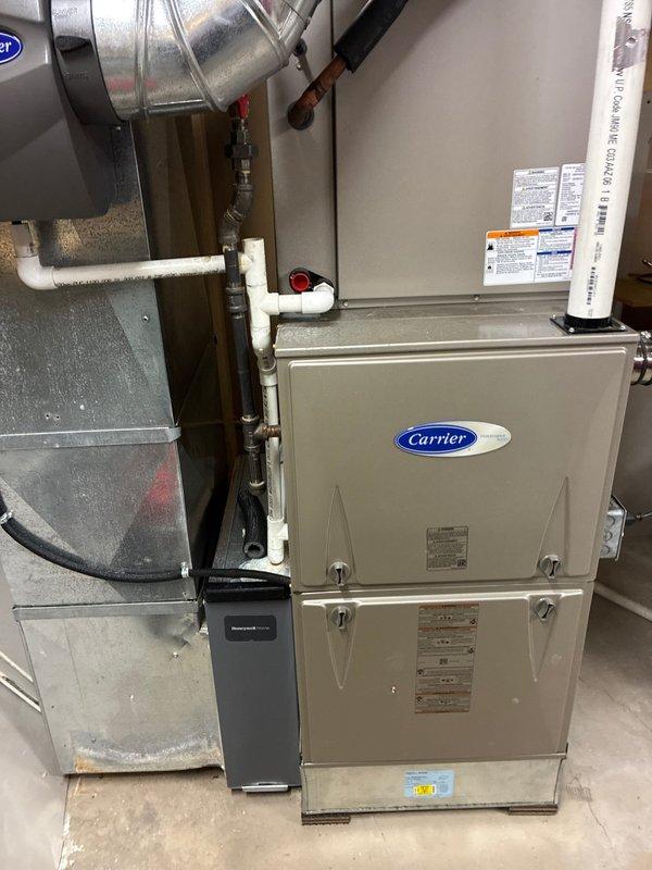 Performed scheduled 4-year maintenance service on Carrier furnace system. Inspected burner assembly, verified proper ignition sequence, and examined electrical connections on control board. All components functioning normally with no issues detected; system left in good working condition.
