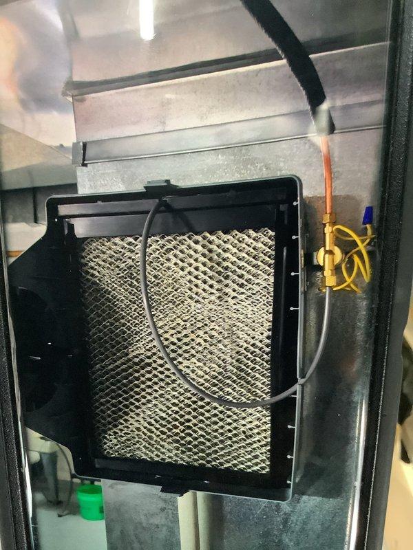 Responded to rolled service call regarding recently installed humidifier with low humidity levels. Inspected HVAC ductwork system and connections, finding proper installation of metal air ducts with cylindrical connector. Examined and verified condition of system filter and associated brass valve/fitting components, ensuring proper airflow for humidification system operation.