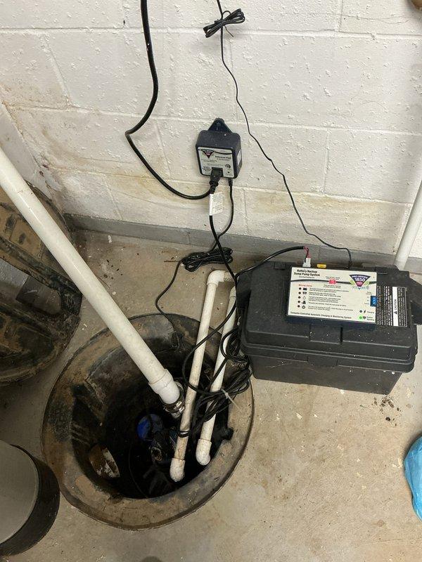 Completed replacement of battery backup system for sump pump installation in basement utility area. Removed old battery backup unit and installed new one, ensuring proper electrical connections to control box and sump pump system. Verified system operation with successful test cycle and documented installation with photos of completed work.