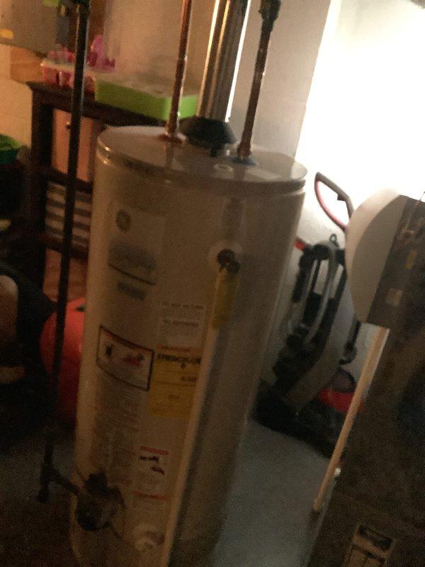 Performed inspection on 15-year-old furnace with confirmed cracked heat exchanger requiring full replacement. Documented condition of existing HVAC system including deteriorated interior insulation and connection points. Also assessed water heater installation with visible copper piping and pressure relief valve. Customer has scheduled follow-up appointment to review replacement options.
