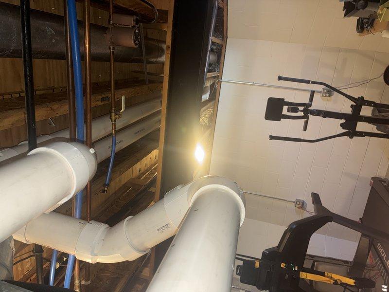 Performed routine MVP heating maintenance service on furnace/air handler system in basement utility area. Inspected all components including blower motor, venting system, and associated PVC exhaust piping. System appears to be functioning properly with no issues identified; installation is well-maintained with secure mounting and proper connections.