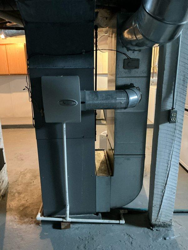 Completed installation of a new 90k BTU HVAC system in residential basement, including proper connection of supply/return ductwork and PVC condensate drainage lines. System features a high-efficiency furnace with standard metal ductwork configuration and was fully tested for proper operation before completion.