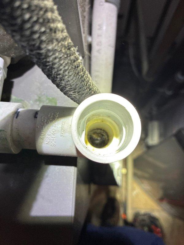 Performed routine maintenance on 2-year-old furnace system. Inspected mechanical components including pipe fittings and identified yellowish fluid with dark residue in the white plastic pipe fitting. Utilized specialized tools to complete the manufacturer-recommended tune-up procedures.