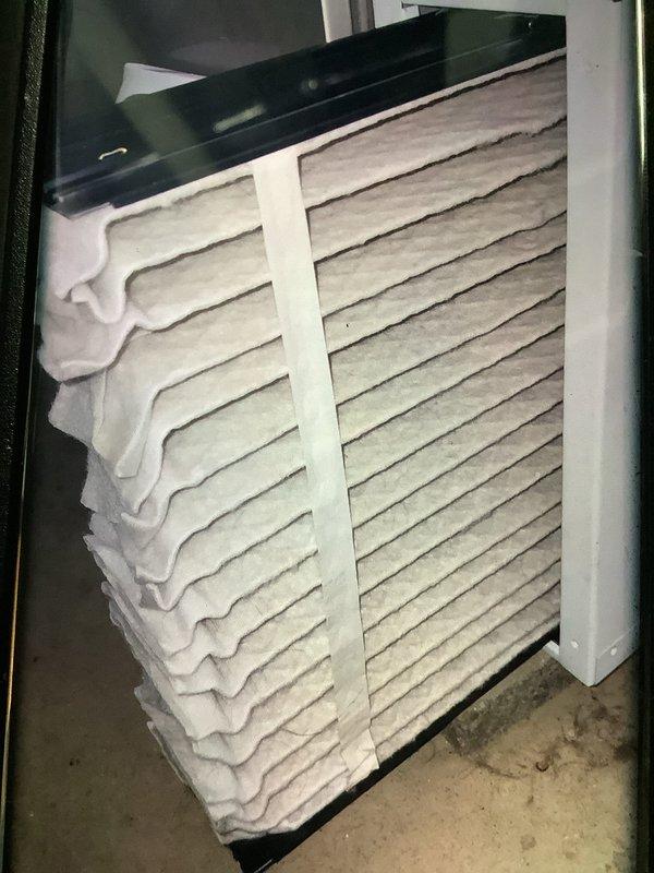Performed diagnostic assessment on furnace system in response to "Outdoor wireless configuration controller" error message displayed on thermostat. Inspected air handler unit in basement utility area and verified filter condition - filter appears to be in good working condition with minimal soiling. Resolved communication issue between thermostat and outdoor unit by reconfiguring wireless controller settings.