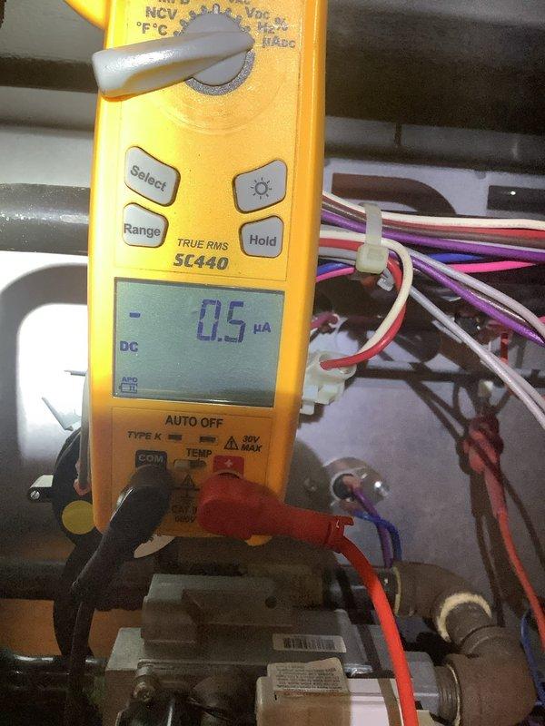 Diagnosed intermittent blower failure on natural gas furnace by inspecting control board and testing electrical components. Multimeter readings revealed low microamp DC current (0.5 μA) at control board connections, indicating faulty flame sensor causing improper fan cycling. Cleaned and replaced flame sensor to restore proper furnace operation before customer's departure.
