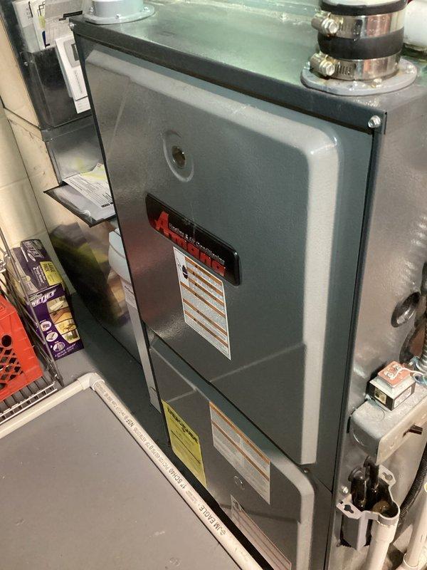 Performed scheduled tune-up on residential HVAC system. Inspected furnace unit and discovered severely clogged air filter with significant dust accumulation. Replaced filter to restore proper airflow and system efficiency.