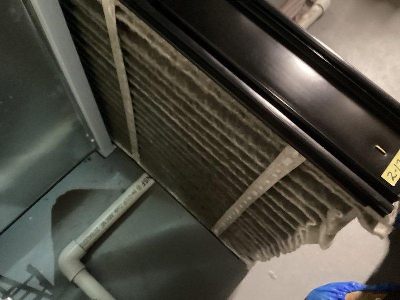 Performed scheduled tune-up on residential HVAC system. Inspected furnace unit and discovered severely clogged air filter with significant dust accumulation. Replaced filter to restore proper airflow and system efficiency.