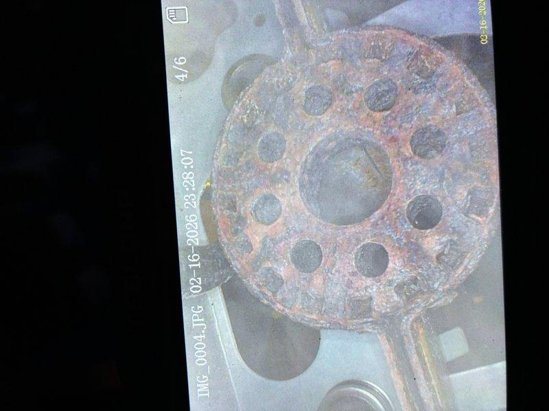 Performed scheduled MVP heating maintenance visit and documented extensive corrosion on drain components. Identified severely rusted strainer plate and flange assembly with advanced oxidation throughout the metal surfaces, suggesting prolonged moisture exposure requiring attention.