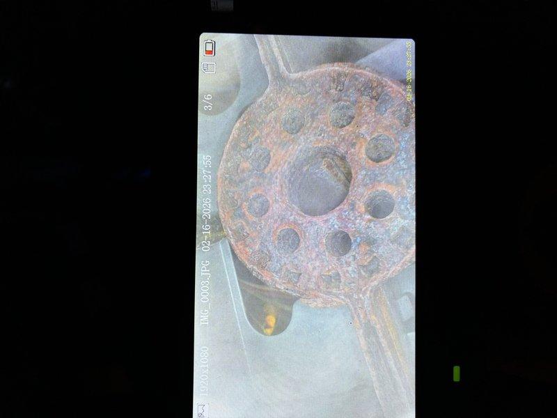 Performed scheduled MVP heating maintenance visit and documented extensive corrosion on drain components. Identified severely rusted strainer plate and flange assembly with advanced oxidation throughout the metal surfaces, suggesting prolonged moisture exposure requiring attention.