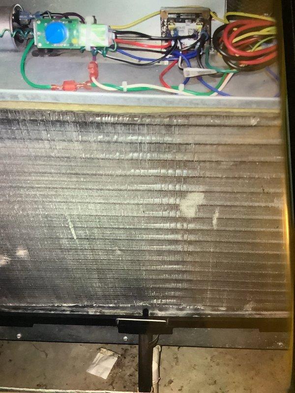 Performed scheduled MVP Heating maintenance service that was rescheduled from previous date. Inspected control wiring connections and examined evaporator coil, noting dust accumulation and minor oxidation on the aluminum fins. Documented system condition with photographs for service record.