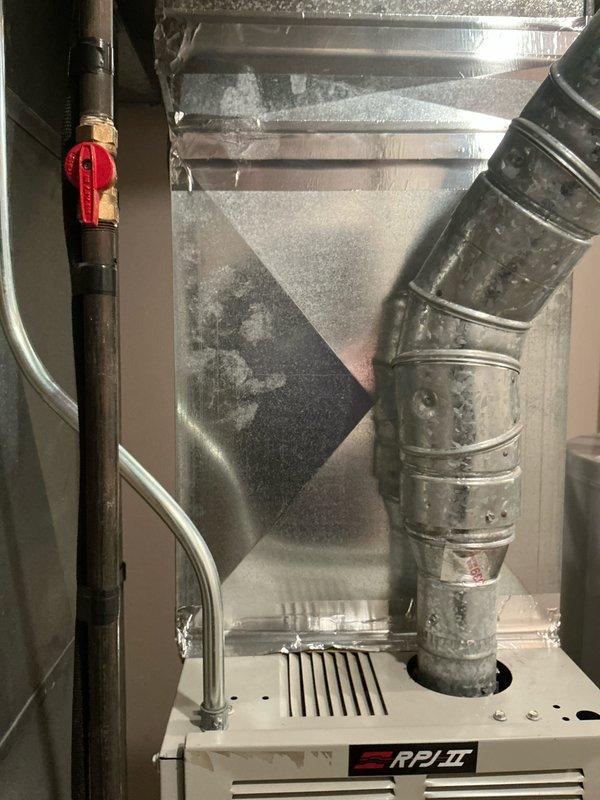 Conducted an HVAC system replacement estimate featuring an RP/II unit with connected galvanized metal ductwork and control valve components. Assessment also included evaluation of existing A.O. Smith Signature water heater showing possible minor leakage indicated by floor discoloration near unit base.
