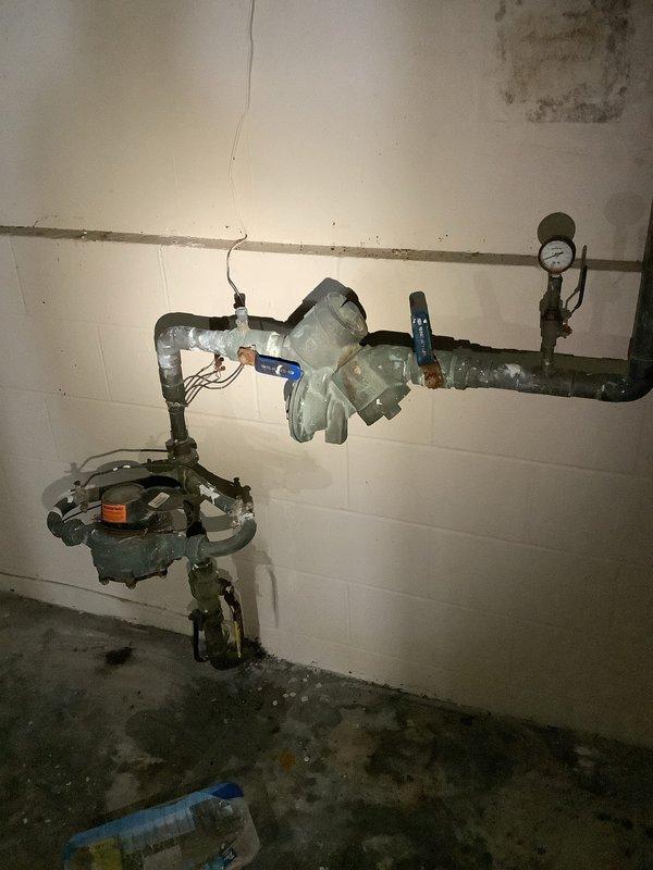 Responded to a no-water service call at a multi-unit building with 3 hot water heaters and a boiler. Inspection revealed significant water damage to structural wood elements with visible deterioration and mold formation. Documented extensive damage to the plumbing system including corroded copper and PVC pipes. Also inspected the pressure regulation system which showed signs of leakage at the regulator/valve assembly and possible issues with the flow control mechanism.