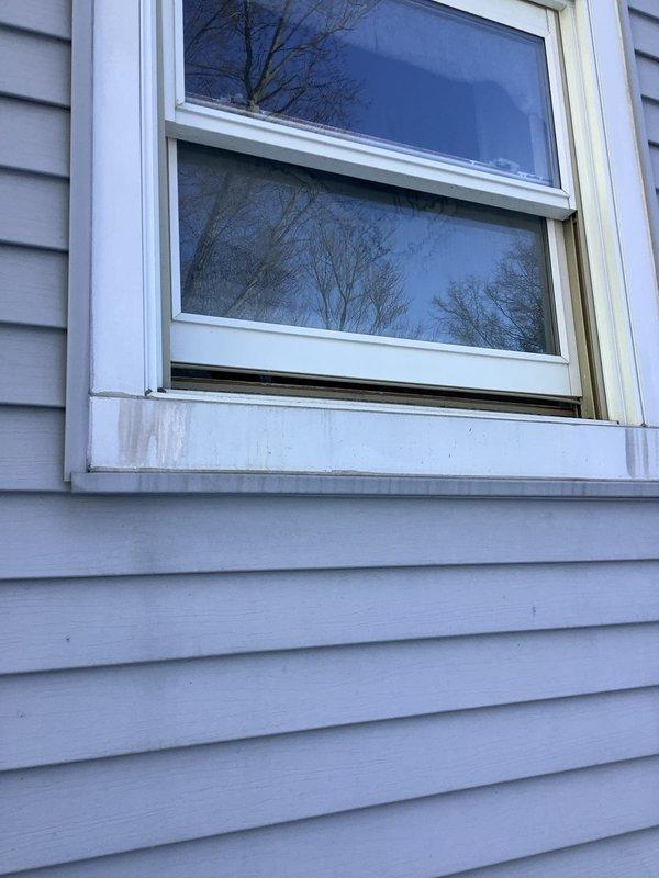 Replaced two straight stops as requested. Observed significant ice formation on exterior wall extending 3-4 feet upward from foundation, indicating potential water leakage issues. Also noted possible water staining beneath window frame with gap at sill that could permit infiltration.