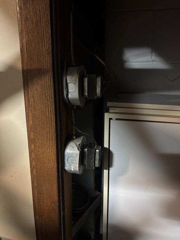 Performed inspection of electrical junction box mounted on wooden framing, identified exposed conductors with yellow wire nuts and improper connections. Resolved safety hazard by properly securing all connections, verifying proper grounding, and ensuring code compliance of the installation.
