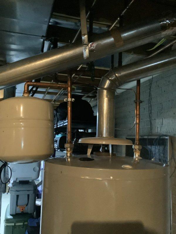 Conducted site assessment for tankless water heater installation, evaluating existing plumbing configuration with current tank-style water heater system. Documented current setup including water lines, gas connections, and venting requirements to prepare comprehensive installation estimate as requested by customer (440-897-4369).